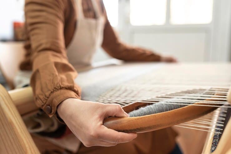 Skilled artisan weaving scarves on handloom at Aleem and Company, Barabanki India